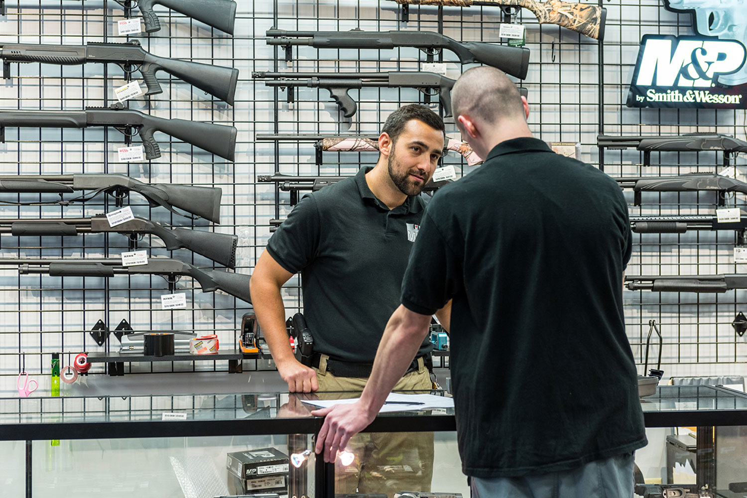 A customer talks with an employee at the Mass Firearms School gun shop